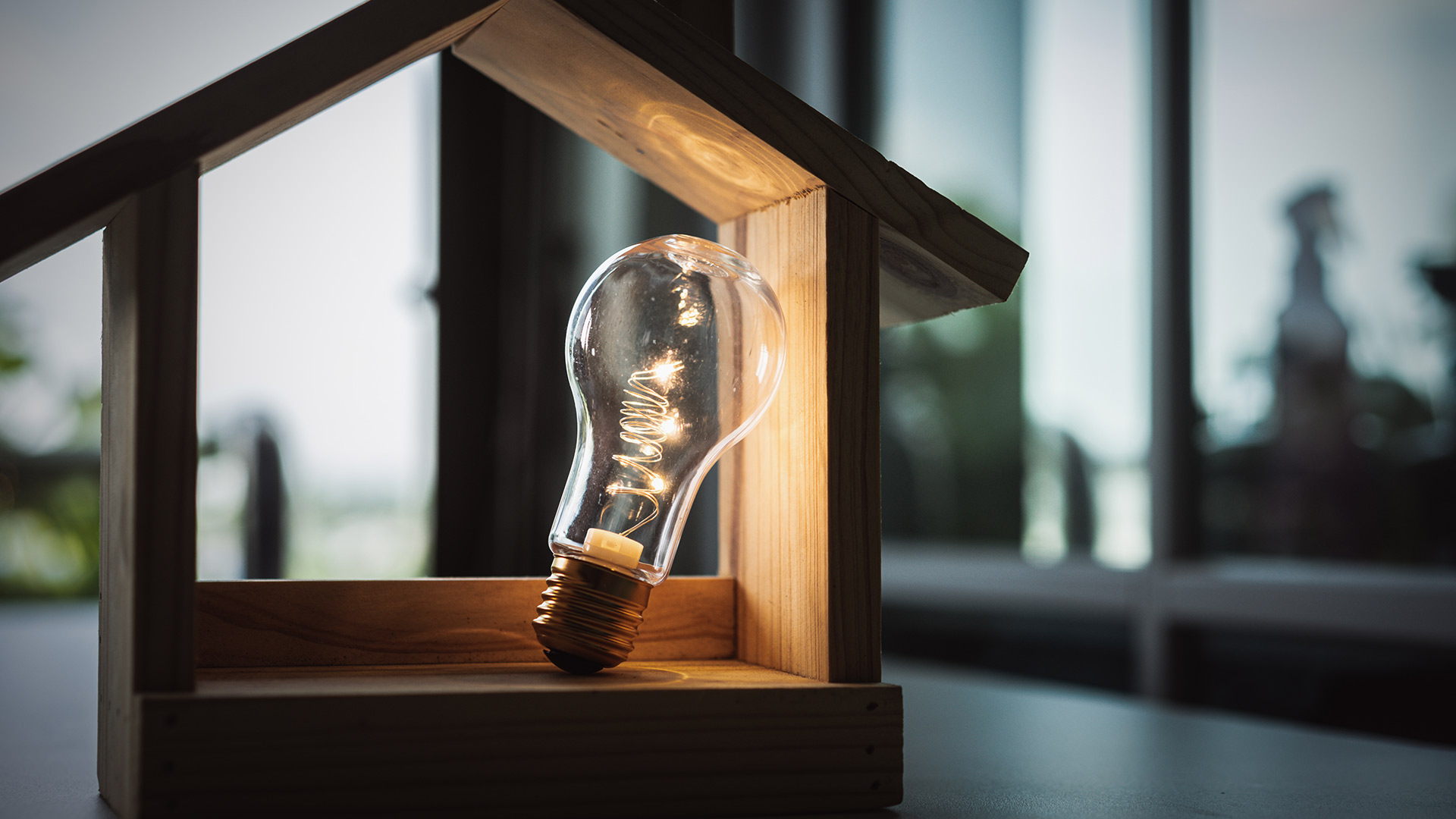 wooden house model with light bulb canton ga