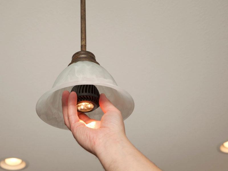 electrician adding a smart bulb in a living room canton ga